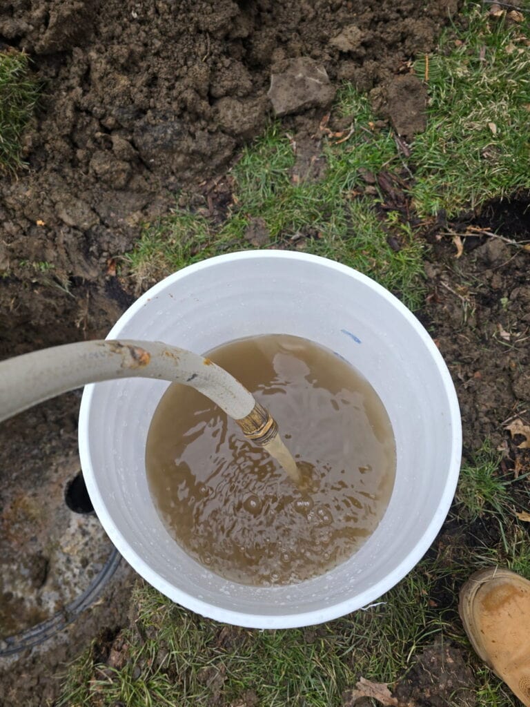 Water flowing from a well during a professional well flow test