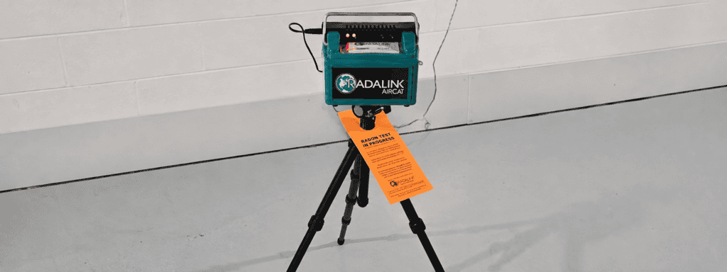 Radalink AirCat radon testing monitor set up on a tripod for professional radon testing.