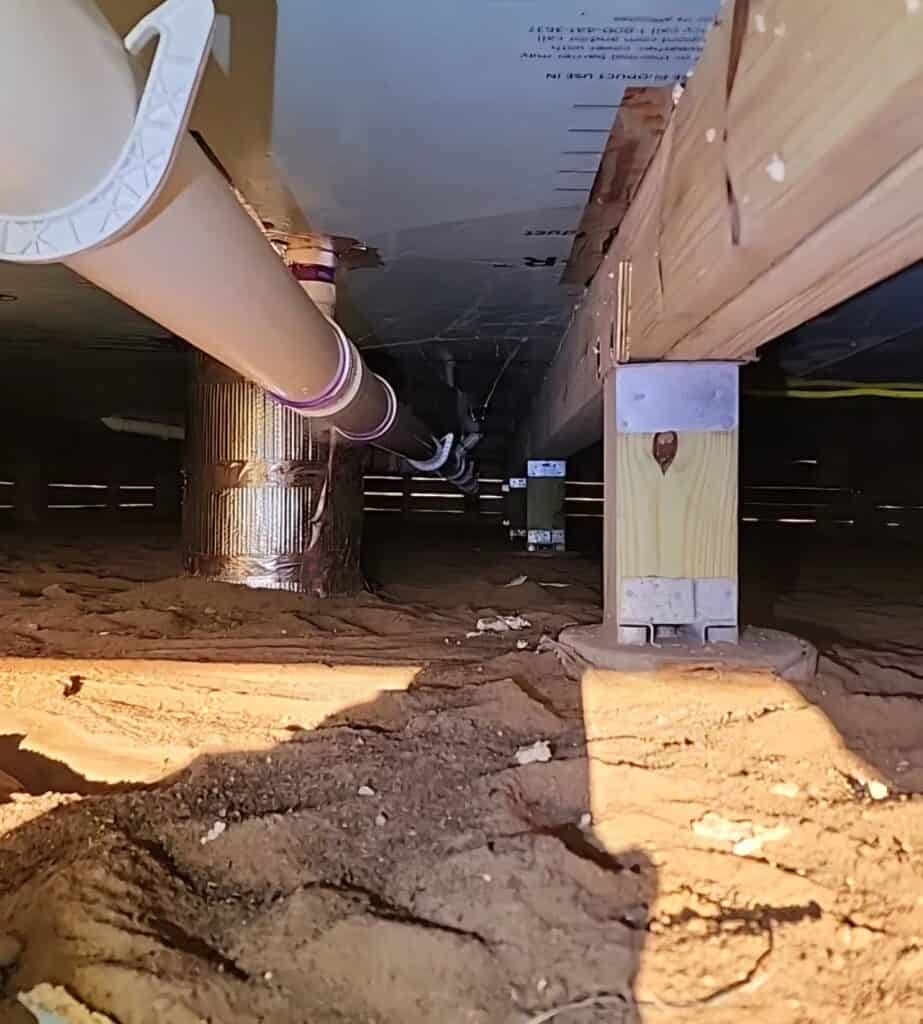 Underground plumbing and foundation support inspection image.