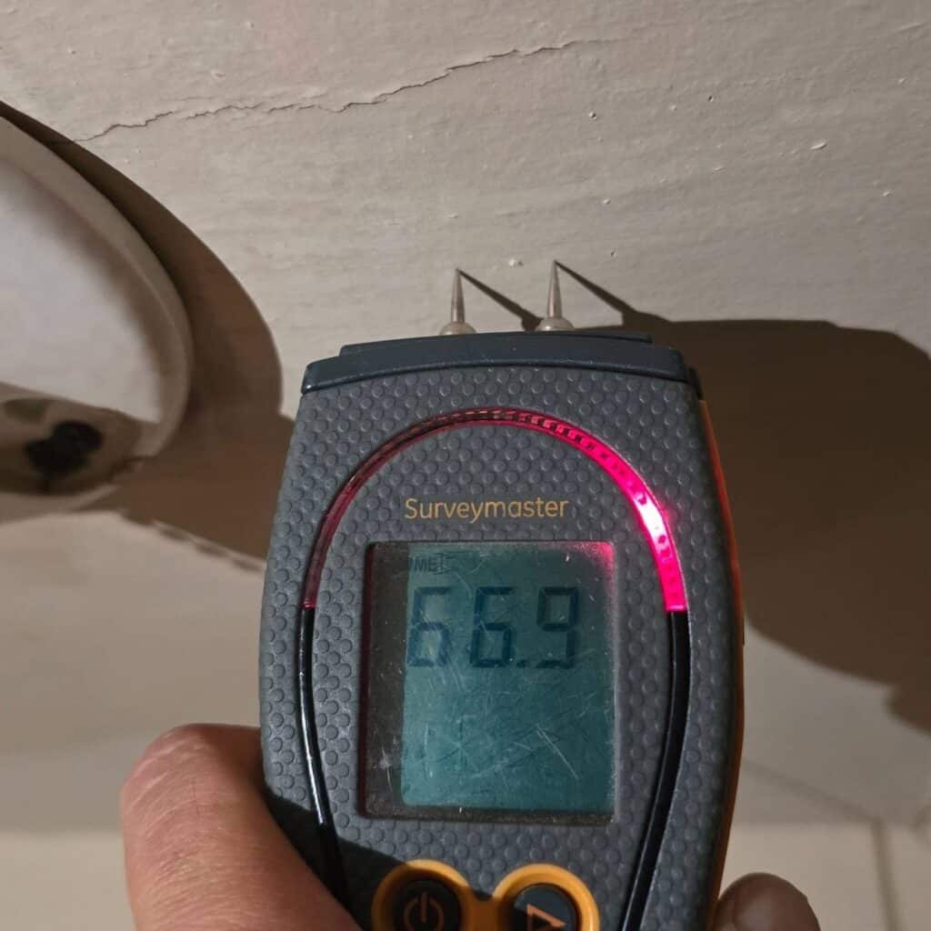 Moisture meter checking a ceiling for elevated moisture during a home inspection