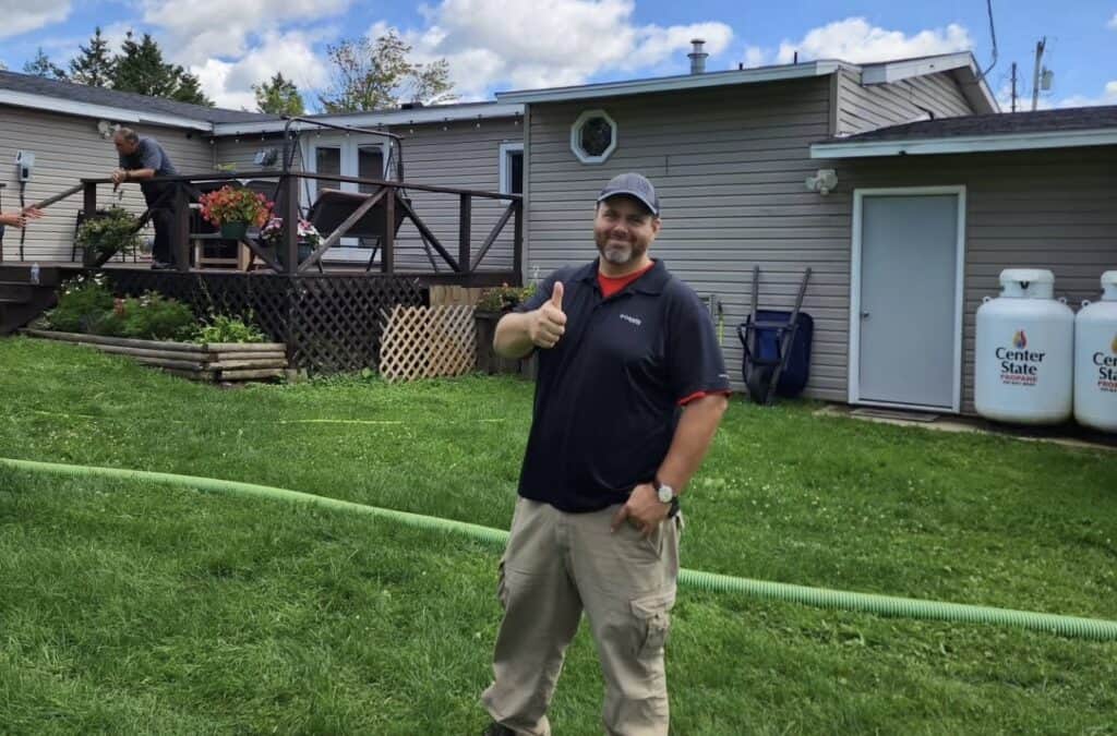 Professional home inspector giving a thumbs up outside a residential property