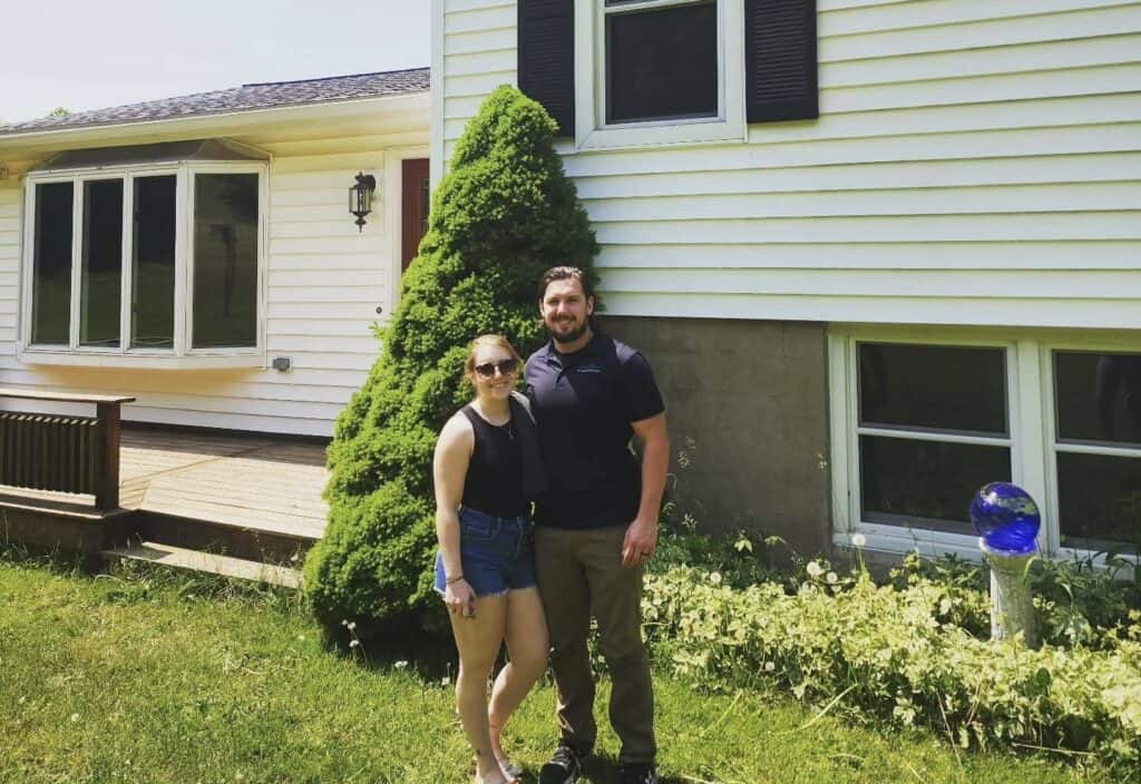 Professional home inspector standing with a client outside a residential home in Central New York