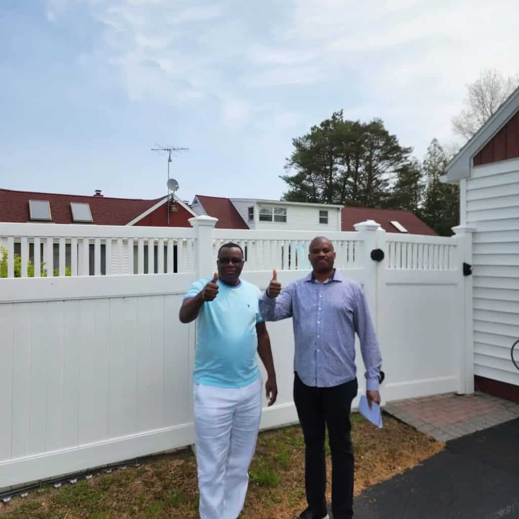 Two men giving thumbs up outside a residential property after a home inspection